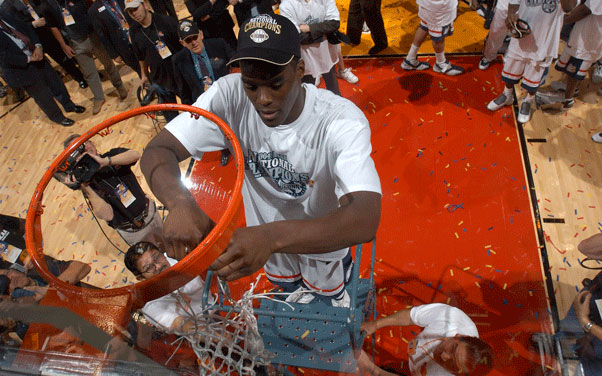 UConn basketball center Emeka Okafor and Most Outstanding Player of the game cuts down the net following the Division I Men's Basketball championship game held at the Alamodome in San Antonio, TX, in April 2004. UConn defeated Georgia Tech 82-73 for the championship title. (Ryan McKee/NCAA Photos)